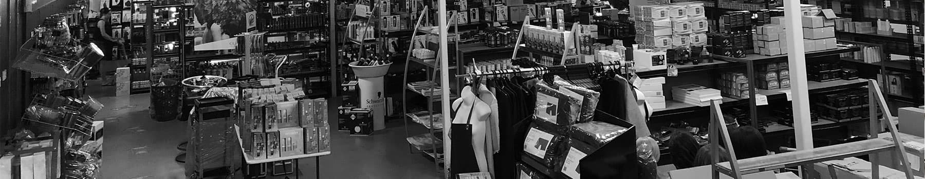 The Norris warehouse floor at 69 Denning Street — shelves of colour, care and salon stock